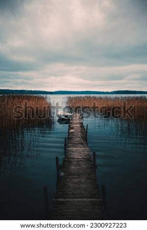 A vertical shot of an old pier by the Vittrask lake in Kirkkonummi, Finland on a gloomy day