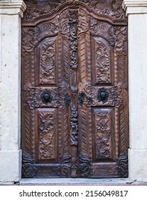 A Vertical Shot Of An Old Wooden Door In Baroque Style