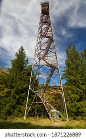 A vertical shot of the Olson Tower surrounded by greenery under a cloudy sky in West Virginia