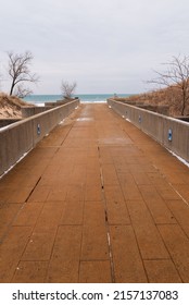 A Vertical Shot Of A Pier In Indiana Dunes National Park, Indiana, USA, Lake Michigan, Great Lakes In Winter