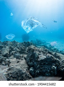 A Vertical Shot Of The Plastic Bags In The Depths Of The Ocean - Water Pollution