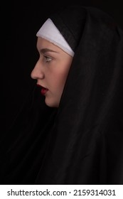 Vertical Shot Profile View Of A Young Sexy Nun Girl. Isoalted On Black Background.