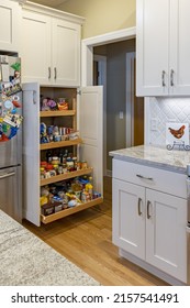 A Vertical Shot Of A Roll Out Pantry Full Of Foodstuff