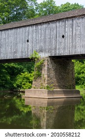 A Vertical Shot Of The Schofield Ford Covered Bridge In Tyler State Park, Pennsylvania On A Sunny Day