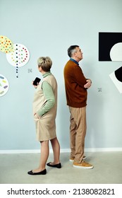 Vertical Shot Of Senior Man And Woman Visiting Contemporary Art Exhibition In Modern Museum