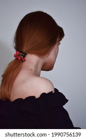 A Vertical Shot Of A Sensual Female With Ginger Hair Tied In A Low Ponytail