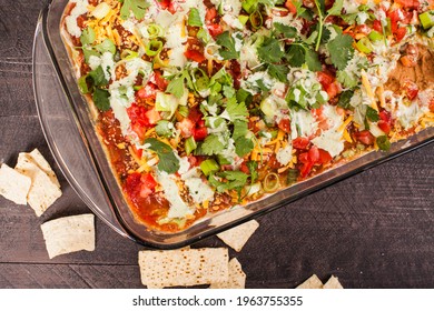 Vertical Shot Of Seven Layer Bean Dip And Tortilla Chips