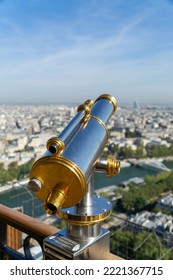 A Vertical Shot Of A Sightseeing Telescope On Top Of The Eifel Tower In Paris, France