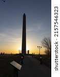 A vertical shot of the silhouette of the Sergeant Floyd Monument against a sunrise sky in Iowa