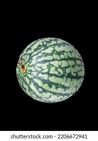 A Vertical Shot Of A Small Green Watermelon Isolated On A Black Background