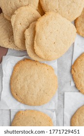 A Vertical Shot Of A Stack Of Homemade Cookies With White Napkins On A Tray