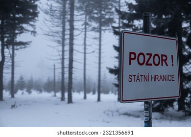 A vertical shot of a state border between Czech and Poland in a snowy cold weather
