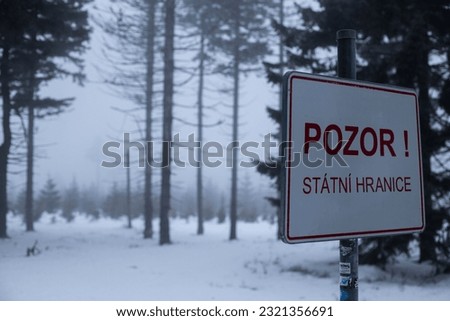 A vertical shot of a state border between Czech and Poland in a snowy cold weather