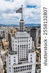 Vertical shot Stunning aerial view from the top of the Altino Arantes building in São Paulo, Brazil, with the city flag flying in the wind