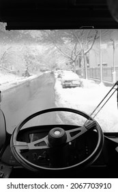 A Vertical Shot Of A Truck Cab With The View To The Snowy Street On A Cold Winter Day