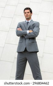 Vertical shot of very confident smug cocky business man executive posing powerful stance