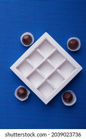 Vertical Shot White Empty Chocolate Box On Blue Background.