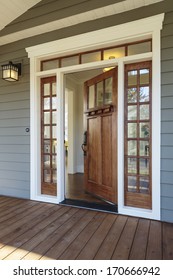 Vertical Shot Of Wooden Front Door  Of An Upscale Home With Windows/Exterior Shot Of An Open Wooden Front Door