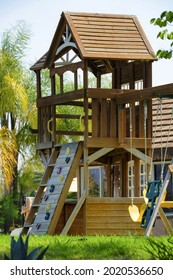 A Vertical Shot Of A Wooden Playhouse In A Park