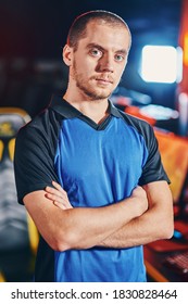 Vertical shot of young confident caucasian guy, male cyber sport gamer keeping arms crossed and looking at camera while participating in eSports tournament or competition - Shutterstock ID 1830828464