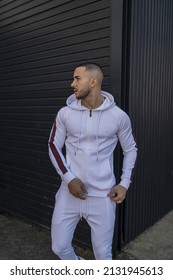 A Vertical Shot Of A Young Cool Hip Male In A White Sweatsuit Posing