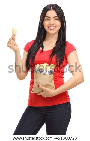 Vertical shot of a young woman eating potato chips from a bag isolated on white background