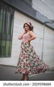 A Vertical Shot Of A Young Woman In A Pink Dress And Flower Hairband