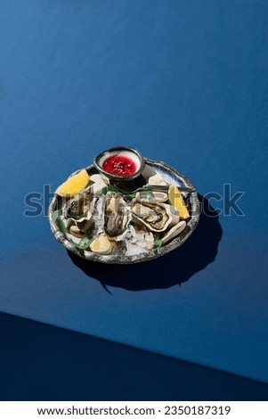 Vertical side view of fresh oysters on ice, served with lemon and vinegar sauce, set in an elegant dining context.