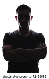 Vertical Silhouette Portrait Of Young Man Folded His Hands On His Chest, Serious Expression, Stern Look