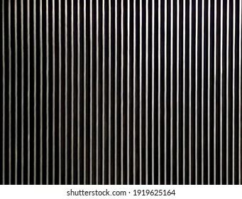 Vertical silver and black stripes,  lines, silver, black, vertical lines, the escalator's surface while standing on the escalator.