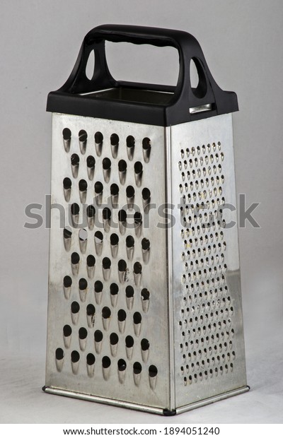 Vertical silver cheese\
grater photography 