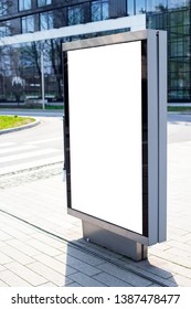 Vertical small billboard in the city on the sidewalk. Mock up for advertising or announcements