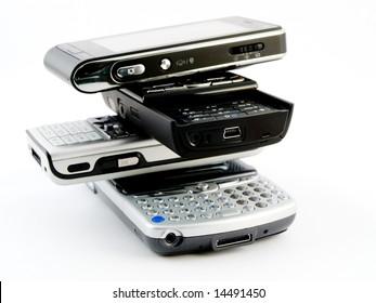 Vertical Stack Pile Of Several Modern Mobile Phones PDA Cell Handheld Units Isolated On White Background