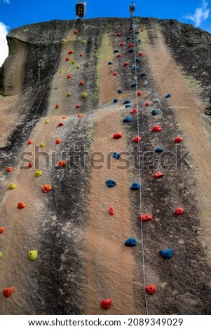 Vertical standstone rock with stripped patterns used for rock climbing 