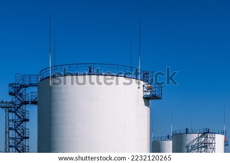 Vertical steel tank for storing petroleum products and flammable liquids. A park for storing petroleum products. Lightning protection device on tanks. Gasoline production.