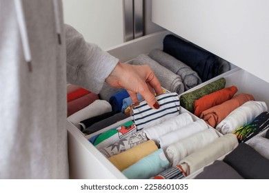 Vertical storage of clothing. Clothing folded for vertical storage in the linen drawer. Nursery. Room interior. - Shutterstock ID 2258601035