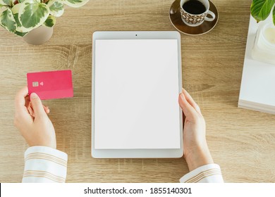 Vertical Tablet Mockup With A Woman Holding A Credit Card In Her Home. Blank Screen To Insert Design. E-commerce Concept