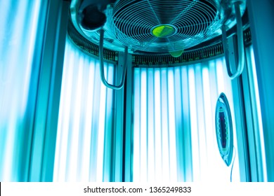 Vertical Tanning Turbo Solarium Light Machine With Glowing Blue Light Ultraviolet Lamps For Tanning And Skin Care. Empty Tanning Modern  Solarium, Inside. Open Solarium Door. Control Panel On The Side