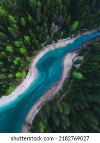 A vertical top view of beautiful glacial river surrounded with evergreen trees in Italy - Shutterstock ID 2182769027