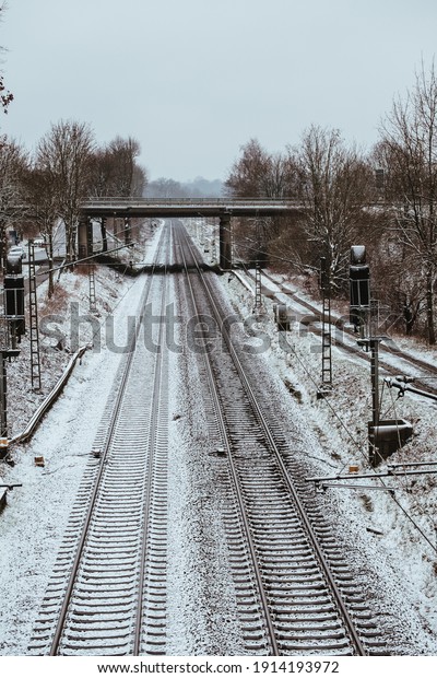 A vertical top view of the railway covered by snow\
in winter