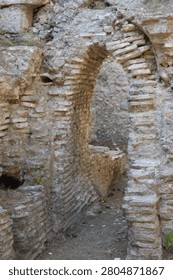 Vertical view of an ancient arched stone doorway at the historical ruins of Phaselis.