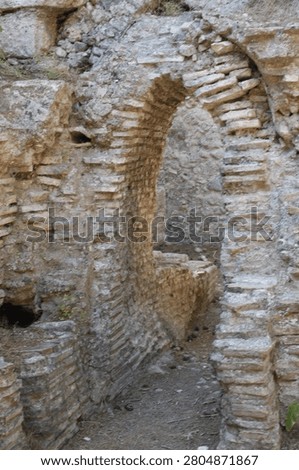 Vertical view of an ancient arched stone doorway at the historical ruins of Phaselis.