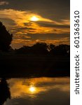 Vertical view of a dramatic sunrise over the Magdalena River in Mompox, Colombia
