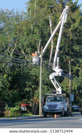 Vertical view of a long, complicated aerial lift or boom that enables landscapers and tree trimmers to reach difficult areas. 