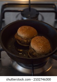 Vertical View Of Mini Veggie Hamburgers Being Heated Up In A Frying Pan.