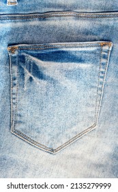 Vertical View Of Old Faded Jeans Back Pocket. Fashion Background