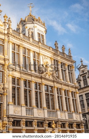 Vertical view of an ornate Baroque guild house facade at the famous Grand Place.
