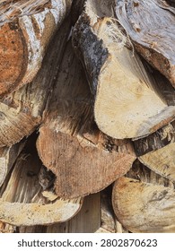 Vertical view of raw timber logs stacked together, showcasing textured lumber and sustainable wooden materials for forestry industry