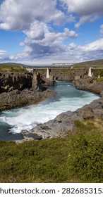 Vertical View of River and Bridge with Rainbow Near Godafoss in Iceland