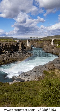 Vertical View of River and Bridge with Rainbow Near Godafoss in Iceland